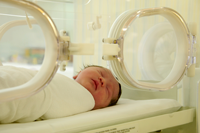 newborn baby in far-infrared-heated incubator